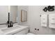 Bathroom featuring a modern vanity, stylish black fixtures, and a neutral color scheme at 64 Via Montoro, Henderson, NV 89011