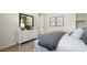 Well-lit bedroom featuring a dresser with mirror and artwork with an open door to closet space at 64 Via Montoro, Henderson, NV 89011