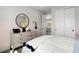 Cozy bedroom with neutral tones, a dresser, and a peek into the upstairs hallway at 64 Via Montoro, Henderson, NV 89011