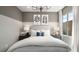 Cozy bedroom with neutral tones, striped bedding, and bedside lamps for a relaxing ambiance at 64 Via Montoro, Henderson, NV 89011
