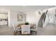 Bright dining area featuring a round table and chairs next to a staircase at 64 Via Montoro, Henderson, NV 89011