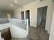Bright upstairs hallway with gray carpet leading to several rooms at 64 Via Montoro, Henderson, NV 89011