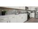 Spacious kitchen with white cabinets, quartz countertops, and stainless steel appliances at 64 Via Montoro, Henderson, NV 89011