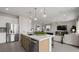 Open-concept kitchen island featuring modern fixtures and seamless flow into the living space at 64 Via Montoro, Henderson, NV 89011