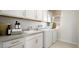 Functional laundry room equipped with washer, dryer, sink, and ample storage at 64 Via Montoro, Henderson, NV 89011