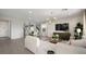 Open-concept living and dining area with modern lighting and comfortable furnishings at 64 Via Montoro, Henderson, NV 89011