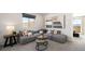Spacious living room with comfortable sofa, scenic views, and stylish decor at 64 Via Montoro, Henderson, NV 89011