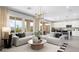 Bright living room seamlessly flows into the kitchen with modern decor and natural light at 64 Via Montoro, Henderson, NV 89011