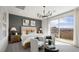 Bright main bedroom with a balcony and view, featuring neutral colors and a modern chandelier at 64 Via Montoro, Henderson, NV 89011