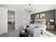 Cozy bedroom with a dark accent wall and comfortable seating area at 64 Via Montoro, Henderson, NV 89011