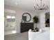 Bright main bedroom with ensuite bathroom, modern chandelier, and black dresser at 64 Via Montoro, Henderson, NV 89011