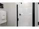 Close-up of a modern shower with white subway tile and sleek black fixtures at 64 Via Montoro, Henderson, NV 89011