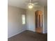 Spacious bedroom with a ceiling fan, neutral colors, and access to the bathroom at 6412 Starling Mesa St, North Las Vegas, NV 89086