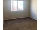 Neutral bedroom featuring plush carpet and a bright window at 6412 Starling Mesa St, North Las Vegas, NV 89086