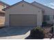 Attached two-car garage with neutral color and adjacent landscaped area at 6412 Starling Mesa St, North Las Vegas, NV 89086