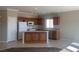 Spacious kitchen with light countertops, tile floors, and oak cabinets at 6412 Starling Mesa St, North Las Vegas, NV 89086