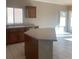 Bright kitchen featuring oak cabinets, light countertops, and tile flooring at 6412 Starling Mesa St, North Las Vegas, NV 89086