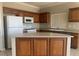 Modern kitchen featuring oak cabinets, stainless appliances, and neutral countertops at 6412 Starling Mesa St, North Las Vegas, NV 89086