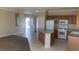 Open concept kitchen with light countertops, tile floors, and a center island at 6412 Starling Mesa St, North Las Vegas, NV 89086