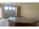 Open-concept living room offering neutral paint, tile flooring, and access to the kitchen at 6412 Starling Mesa St, North Las Vegas, NV 89086