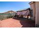 Spacious backyard featuring brick pavers and a covered patio area at 6520 Blooming Sun Ct, Las Vegas, NV 89142