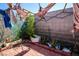View of backyard with brick ground cover, and cinder block wall with an assortment of plants at 6520 Blooming Sun Ct, Las Vegas, NV 89142