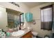 Bathroom featuring a vanity with granite counters, a large mirror, and decorative blue accents at 6520 Blooming Sun Ct, Las Vegas, NV 89142