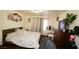 Bedroom featuring wood floors, a floral painting, curtains, and a vanity table at 6520 Blooming Sun Ct, Las Vegas, NV 89142