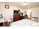 Bedroom features a patterned comforter, wood floors, and en-suite bathroom access at 6520 Blooming Sun Ct, Las Vegas, NV 89142