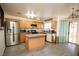 Modern kitchen featuring stainless steel appliances, light wood cabinets, and a center island at 6520 Blooming Sun Ct, Las Vegas, NV 89142