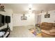 Spacious living room featuring tile flooring, ceiling fan and lots of natural light at 6520 Blooming Sun Ct, Las Vegas, NV 89142