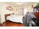 Comfortable main bedroom with wood flooring, neutral walls and a matching dresser at 6520 Blooming Sun Ct, Las Vegas, NV 89142