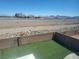 Backyard featuring artificial turf, brick walls, and distant mountain views at 7102 Shimmering Ave, Henderson, NV 89011