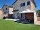 A backyard with artificial turf, a covered patio, and an outdoor grill at 7102 Shimmering Ave, Henderson, NV 89011