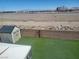 A serene backyard featuring artificial turf, a storage shed, and mountain views at 7102 Shimmering Ave, Henderson, NV 89011