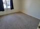 Bedroom showcasing neutral carpet, light walls, and natural light from a window at 7102 Shimmering Ave, Henderson, NV 89011