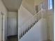 Bright entryway featuring a carpeted staircase with white railing and a high ceiling at 7102 Shimmering Ave, Henderson, NV 89011