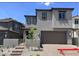 Two-story home featuring a two-car garage, gray stucco, and a landscaped front yard with steps leading to the entry at 72 Via Montoro, Henderson, NV 89011