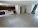 Expansive open-concept living area with tile flooring, a large kitchen island, and stairs leading to the upper level at 72 Via Montoro, Henderson, NV 89011
