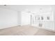Bright, open loft area with neutral carpet, white walls, and staircase access at 72 Via Montoro, Henderson, NV 89011