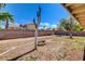 Expansive backyard featuring a block wall, fire pit, and clear blue sky at 7417 Radville Dr, Las Vegas, NV 89129