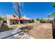 Spacious backyard featuring a block wall, clear blue sky, and palm trees at 7417 Radville Dr, Las Vegas, NV 89129