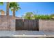 Backyard featuring a dark wood gate within a block wall at 7417 Radville Dr, Las Vegas, NV 89129