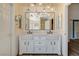 Modern bathroom features double vanity, stylish lighting, and neutral tones at 7417 Radville Dr, Las Vegas, NV 89129