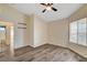 Bedroom featuring wood-look flooring, ceiling fan, and ample natural light at 7417 Radville Dr, Las Vegas, NV 89129