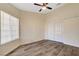 Bedroom with modern wood-look flooring and double door closet. Large window with blinds at 7417 Radville Dr, Las Vegas, NV 89129