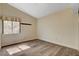 Bright bedroom featuring wood-look flooring and a window with neutral-toned walls at 7417 Radville Dr, Las Vegas, NV 89129