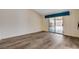 Spacious bedroom with slider to yard, featuring wood-look flooring and ample natural light at 7417 Radville Dr, Las Vegas, NV 89129