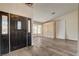 Welcoming entryway with a dark wood front door and views of the bright living area with a bay window at 7417 Radville Dr, Las Vegas, NV 89129