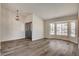 Welcoming entryway with a dark wood front door and views of the bright living area with a bay window at 7417 Radville Dr, Las Vegas, NV 89129